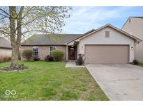 Charming single story home with a well-manicured lawn and attached two car garage at 12949 Shandon Ln, Fishers, IN 46038