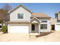 Inviting two-story home featuring a one-car garage, charming front porch, and beautifully maintained landscaping at 2421 Grand Fir Dr, Greenwood, IN 46143