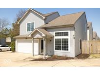 Charming two-story home with a one-car garage and a covered front entryway with bright windows at 2421 Grand Fir Dr, Greenwood, IN 46143