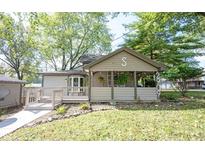 Charming home featuring a welcoming front porch and meticulously maintained landscaping at 2909 Huntsville Rd, Pendleton, IN 46064