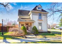 Charming two-story home featuring a dormer window, quaint front porch, and well-maintained lawn at 331 W State St, Pendleton, IN 46064