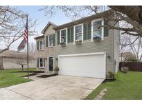 Charming two-story home with a two-car garage and flower boxes under the windows at 5869 Jamestown Square Ln, Indianapolis, IN 46234