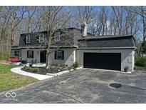 Charming gray brick home featuring a black roof, dormer windows, and a two-car attached garage at 788 S Harbour Dr, Noblesville, IN 46062