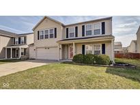 Charming two-story home features a two-car garage, well-maintained lawn, and classic architectural details at 8316 S Swimming Hole Ln, Pendleton, IN 46064