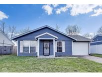 Charming one-story home features a blue exterior, white trim, and an attached one-car garage at 9525 Meadowlark Dr, Indianapolis, IN 46235