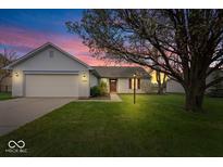 Charming single-story home with a well-maintained lawn, attached two-car garage, and inviting curb appeal at 9856 Commonwealth Dr, Fishers, IN 46038