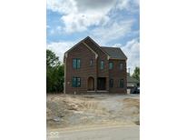 New two-story brick home featuring large windows and an arched front entry at 20598 Chatham Creek Dr, Westfield, IN 46074