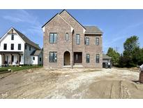 New construction home featuring a brick facade, arched entryway and black window frames at 20598 Chatham Creek Dr, Westfield, IN 46074