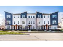 Modern townhome featuring a mix of gray and white siding, dark blue accents, and sleek architectural lines at 2907 Kirkbride Way, Indianapolis, IN 46222