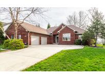 Charming red brick home featuring an attached two-car garage and a concrete driveway at 3927 S Cedar Creek Ln, New Palestine, IN 46163