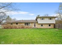 Charming home featuring a well-maintained lawn and a unique stone and siding facade at 4108 Carson Ave, Indianapolis, IN 46227
