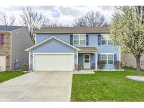 Two-story home featuring light blue siding, an attached two-car garage, and a well-manicured lawn at 4135 Benicia Ln, Indianapolis, IN 46235