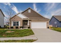 Charming single-Gathering home featuring a brick facade, landscaped yard, and attached two-car garage at 462 N Crystal Dr, Fortville, IN 46040