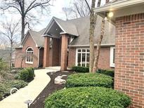 Charming brick home featuring manicured landscaping and inviting walkway at 4631 Hickory Ct, Zionsville, IN 46077