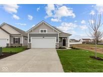 Charming gray home with a two-car garage and well-manicured lawn at 5211 Rolling Meadow Blvd, Indianapolis, IN 46237