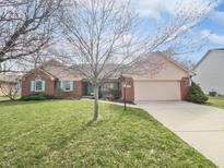Charming single-story home with a well-manicured lawn and attached two car garage at 603 Raintree Dr, Avon, IN 46123