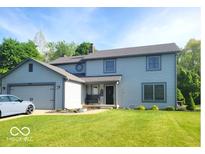 Charming two-story home with landscaped yard and attached two-car garage at 7231 W Anton Way, New Palestine, IN 46163