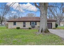 Charming single-story home featuring a stone facade, attached garage, and well-manicured lawn at 1114 S Avon Ave, Avon, IN 46123