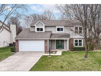 Charming two-story home featuring a well-maintained lawn, attached two-car garage, and welcoming front entrance at 12527 Trester Ln, Fishers, IN 46038