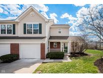 Charming townhome featuring a brick accent, attached garage, and well-maintained landscaping at 1561 Brookfield Cir, Franklin, IN 46131