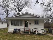 Modest single-story home with vinyl siding, front porch, and a small accessibility ramp at 2194 N Riley Ave, Indianapolis, IN 46218