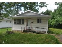 Modest single-story home featuring a small front yard and accessible ramp at 2194 N Riley Ave, Indianapolis, IN 46218