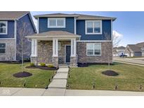 Charming two-story home with stone accents, a covered porch, and a well-maintained lawn at 2532 Barstow Dr, Whitestown, IN 46075