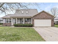 Charming single-Gathering home featuring a covered porch and attached two-car garage at 325 St Charles Way, Whiteland, IN 46184