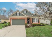 Charming brick home with a well-manicured lawn and a two-car garage, perfect for suburban living at 3444 Windy Knoll Ln, Carmel, IN 46074