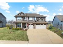 Inviting two-story home featuring a three-car garage and manicured front lawn at 4148 Basswood Dr, Danville, IN 46122