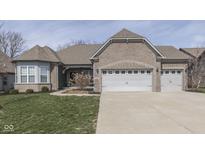 Attractive brick home with a three car garage and well-maintained lawn at 4182 Backstretch Ln, Bargersville, IN 46106