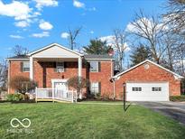 Beautiful two-story brick home with an attached garage and landscaped lawn at 44 Horseshoe Ln, Carmel, IN 46033