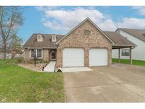 Charming brick home featuring an attached two-car garage, well-manicured lawn, and inviting curb appeal at 607 N White Ash N Ct, Mooresville, IN 46158