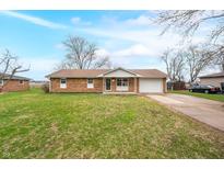 Charming brick home with well-maintained lawn and attached garage at 782 N Dellasburg Rd, Columbus, IN 47203