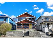 Charming two-story home featuring a welcoming front porch, updated siding, and well-maintained landscaping at 934 E Minnesota St, Indianapolis, IN 46203