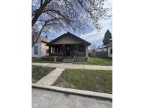 Charming bungalow with a brick foundation, covered porch, and a mature tree in the front yard at 1437 S Reisner St, Indianapolis, IN 46221