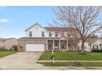 Two-story brick and vinyl home with attached two car garage, covered front porch, and well-kept lawn at 15885 Symphony Blvd, Noblesville, IN 46060