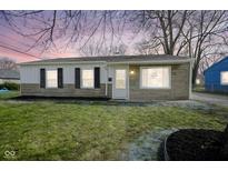Charming single-story home with stone accents and a well-maintained lawn at 2467 Sickle Rd, Indianapolis, IN 46219