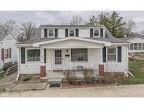 Charming two-story home with white siding, black shutters, and a cozy front porch at 319 Alice St, Shelbyville, IN 46176