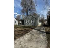 Charming single-Gathering home with a well-maintained front yard and a long concrete driveway leading to a detached garage at 3521 N Rural St, Indianapolis, IN 46218