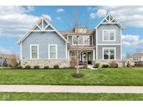 Beautiful two-story home featuring stone accents and a well-manicured lawn at 3645 Conifer Dr, Zionsville, IN 46077