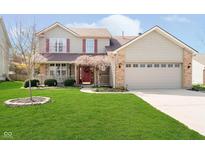 Charming two-story home featuring a well-manicured lawn and a welcoming front porch at 6134 Chadsworth Way, Lawrence, IN 46236