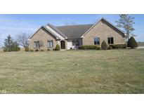 Charming single story brick home with a well-maintained lawn and manicured shrubbery at 7685 S 25 W, Lebanon, IN 46052