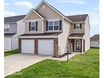 Two-story home with brick accents, an attached two-car garage, and a well-maintained lawn at 15444 Old Pond Cir, Noblesville, IN 46060