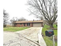 Charming single-story brick home with a two-car garage and long driveway at 1761 Country Lane Dr, Greenfield, IN 46140