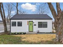 Charming home featuring a new roof, fresh white siding, black trim and a bright green front door at 3105 N Tacoma Ave, Indianapolis, IN 46218