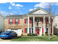 Charming two-story brick home with red shutters, grand white columns, and a well-manicured lawn at 320 Legacy Blvd, Greenwood, IN 46143