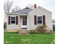 Charming home with vinyl siding, a brick chimney, and cute red shutters at 3420 N Chester Ave, Indianapolis, IN 46218