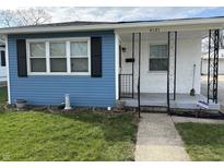 Charming home front porch with decorative iron railings and freshly painted accents at 4121 Fletcher Ave, Indianapolis, IN 46203