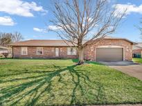 Charming single-story brick home with a well-maintained lawn and attached garage at 641 Beech W Dr, Plainfield, IN 46168
